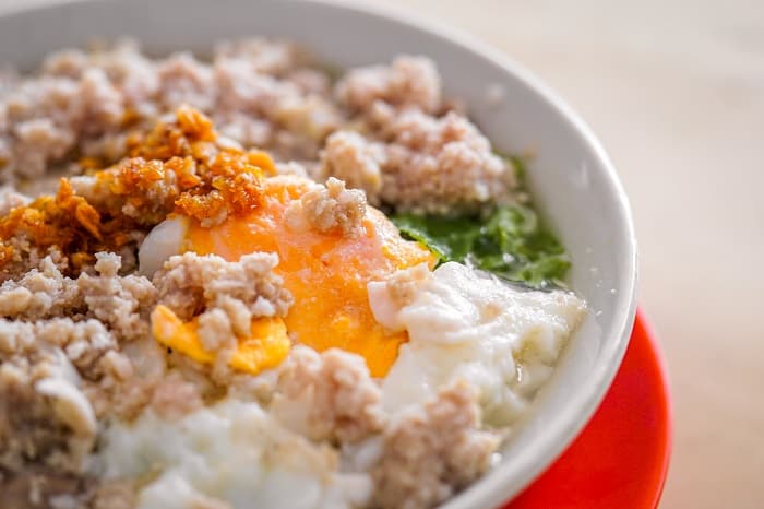 Japanese breakfast bowl with rice, egg, nori, and crumbled chicken